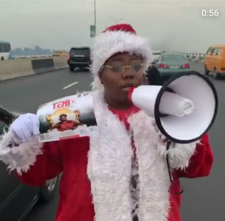 Teni Rocks Father Christmas Costume, Begs People On The Road To Come To Her Show 7