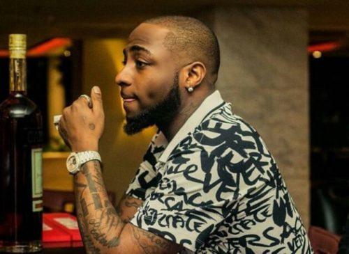 Davido Expresses Shock As Strange Woman Tattoos His Family On Her Back. 3